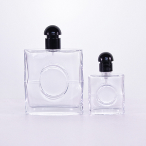 中央の黒いプラスチックの蓋に円が付いたフラットな香水瓶